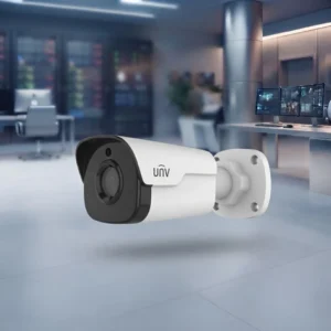 Close-up view of a white Uniview (UNV) bullet CCTV security camera with clear lens and 'unv' branding, floating cleanly against a blurred modern surveillance control room background.